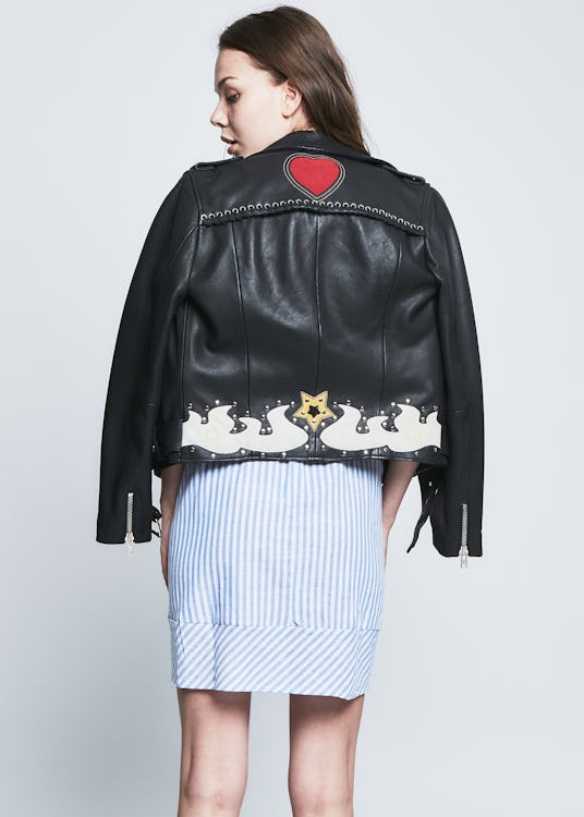 Female model in a black leather jacket and light blue skirt from the RARELY collection