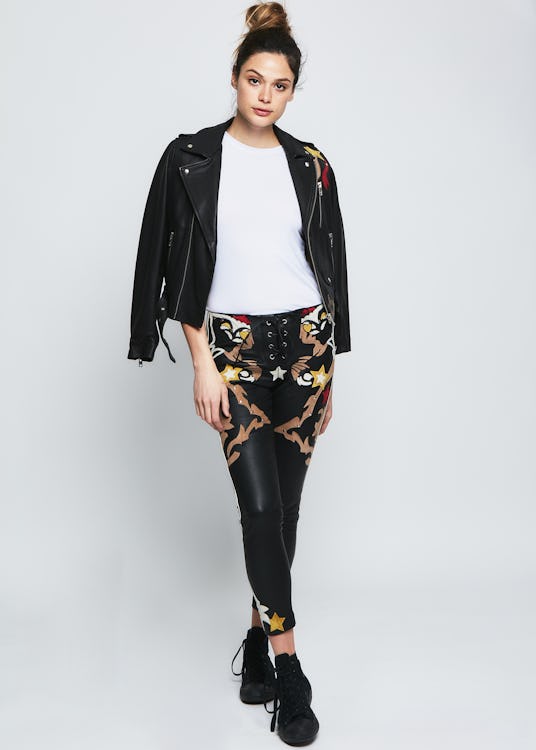Female model in a black leather jacket and pants and a white shirt from the RARELY collection