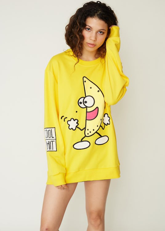 A brunette woman in a yellow dancing banana sweatshirt