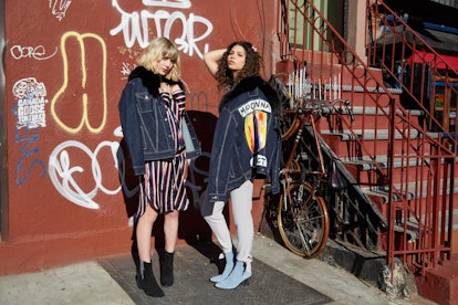 Saint Vivian Wrath jackets worn by models in front of a wall with graffiti