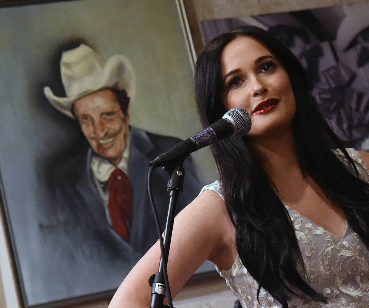 Kacey Musgraves performing in a grey sleeveless embroidered dress