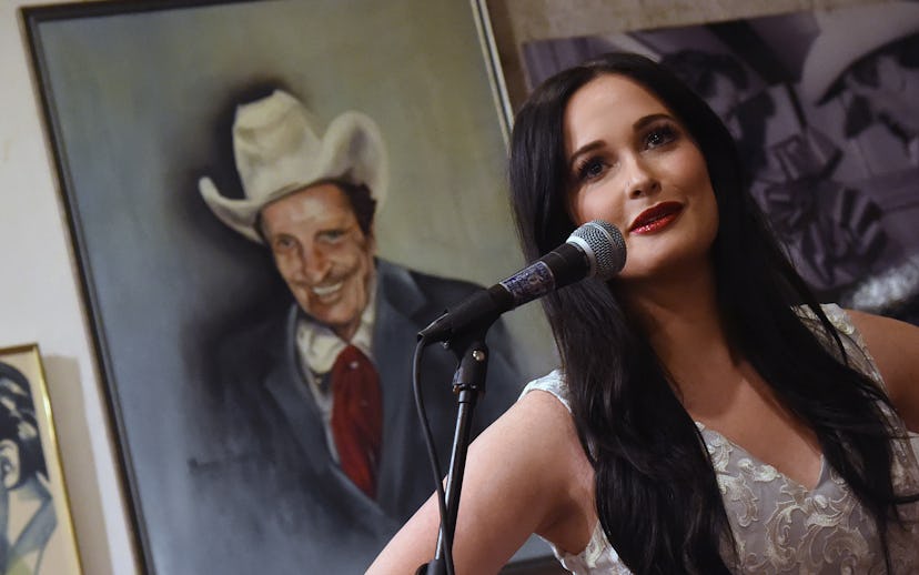 Kacey Musgraves performing in a grey sleeveless embroidered dress