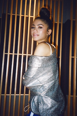 Zendaya posing in a glittery shirt 