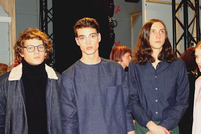 Three male models posing for a photo at the Berlin Fashion Week