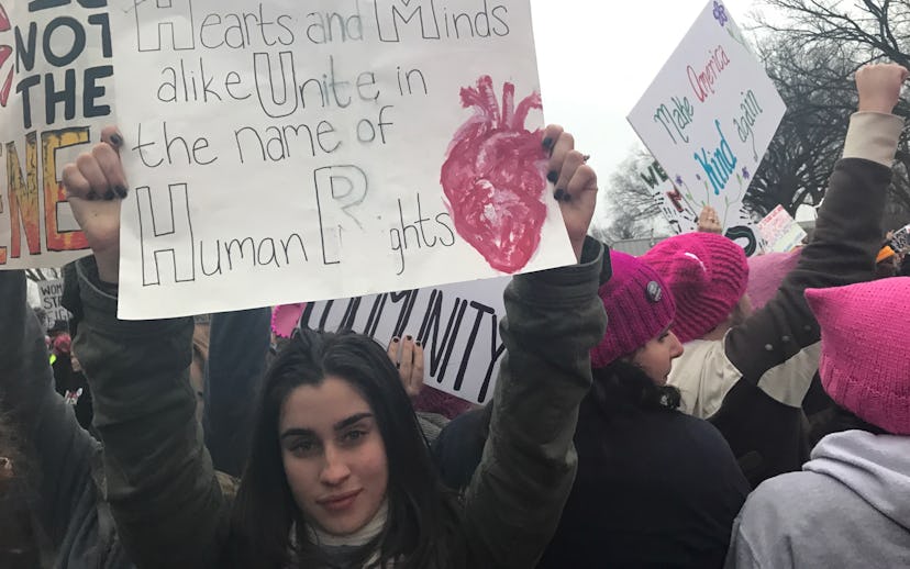 Fifth Harmony's Lauren Jauregui at a Women's March with a sign "Hearts and Minds alike Unite in the ...