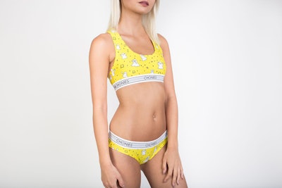 Female model posing in cute matching yellow undies and a sports bra from Chonies