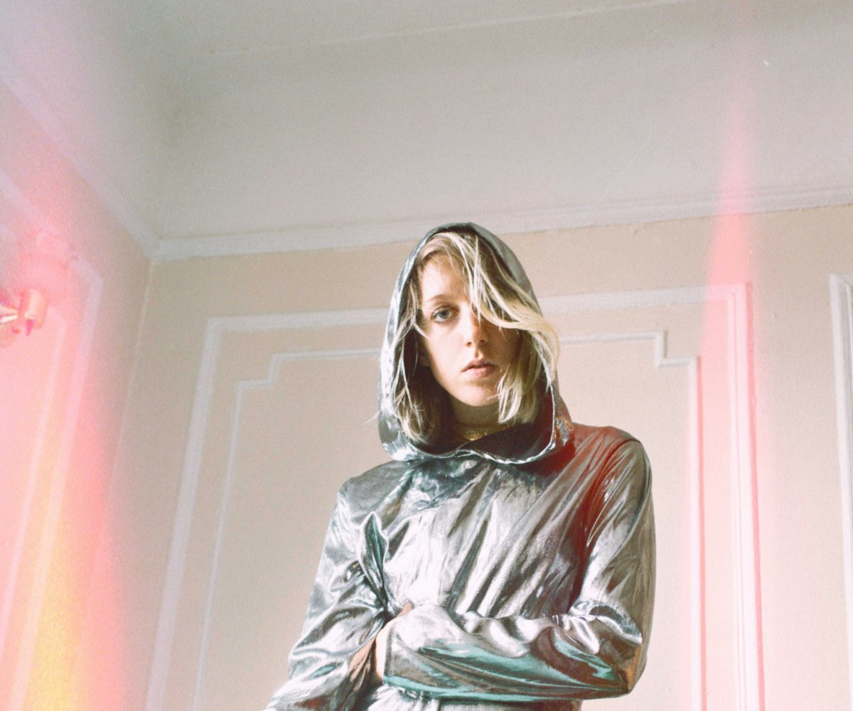 Errmine wearing a silver jacket for the cover of her debut single Driver's seat