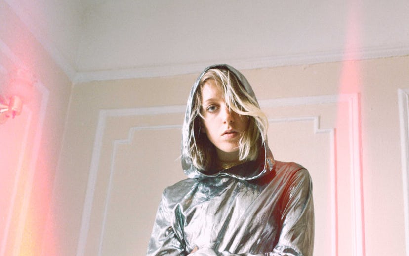 Errmine wearing a silver jacket for the cover of her debut single Driver's seat