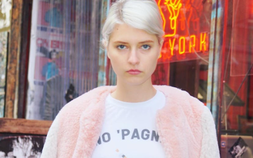 Blonde girl wearing a "No pain no gain" shirt and a pink fur jacket