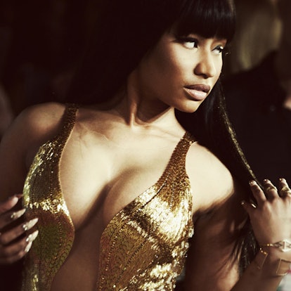 Nicki Minaj with bangs in a golden costume with deep cleavage