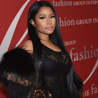 Nicki Minaj with straight hair posing in a black lace dress