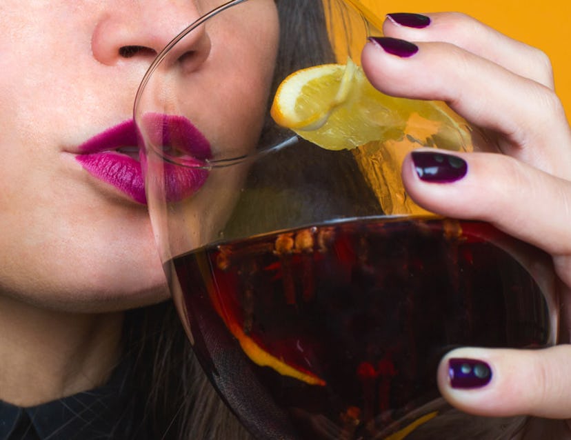 A woman drinking a black winter drink