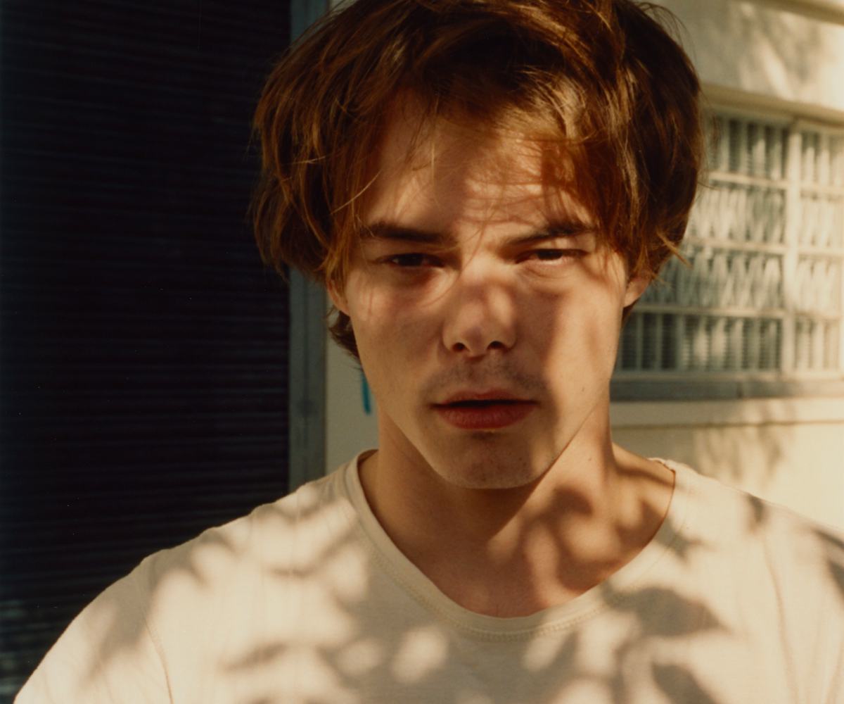 Stranger Things' Charlie Heaton in the shade under a tree