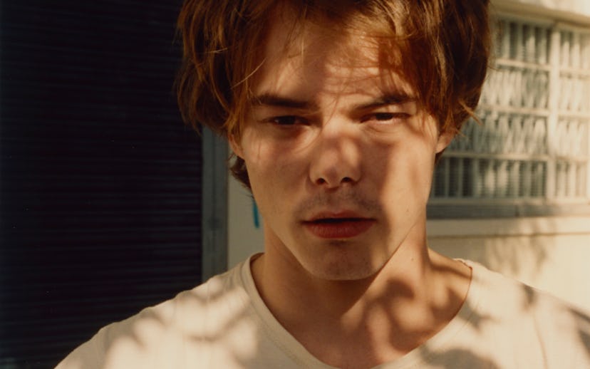 Stranger Things' Charlie Heaton in the shade under a tree