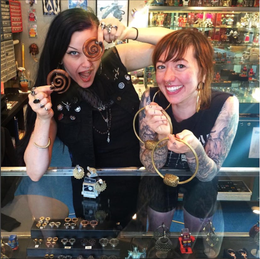 Two women standing in the Robot Piercing and Tattoo studio