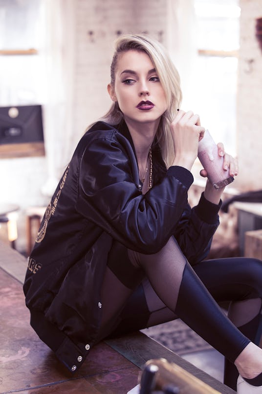 Beatriz Grander posing in black leggings by SophiReaptress and The Gang Bomber Jacket by Chi Flo