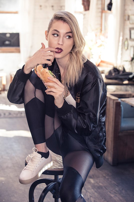 Beatriz Grander eating a sandwich in black leggings by SophiReaptress and The Gang Bomber Jacket by ...