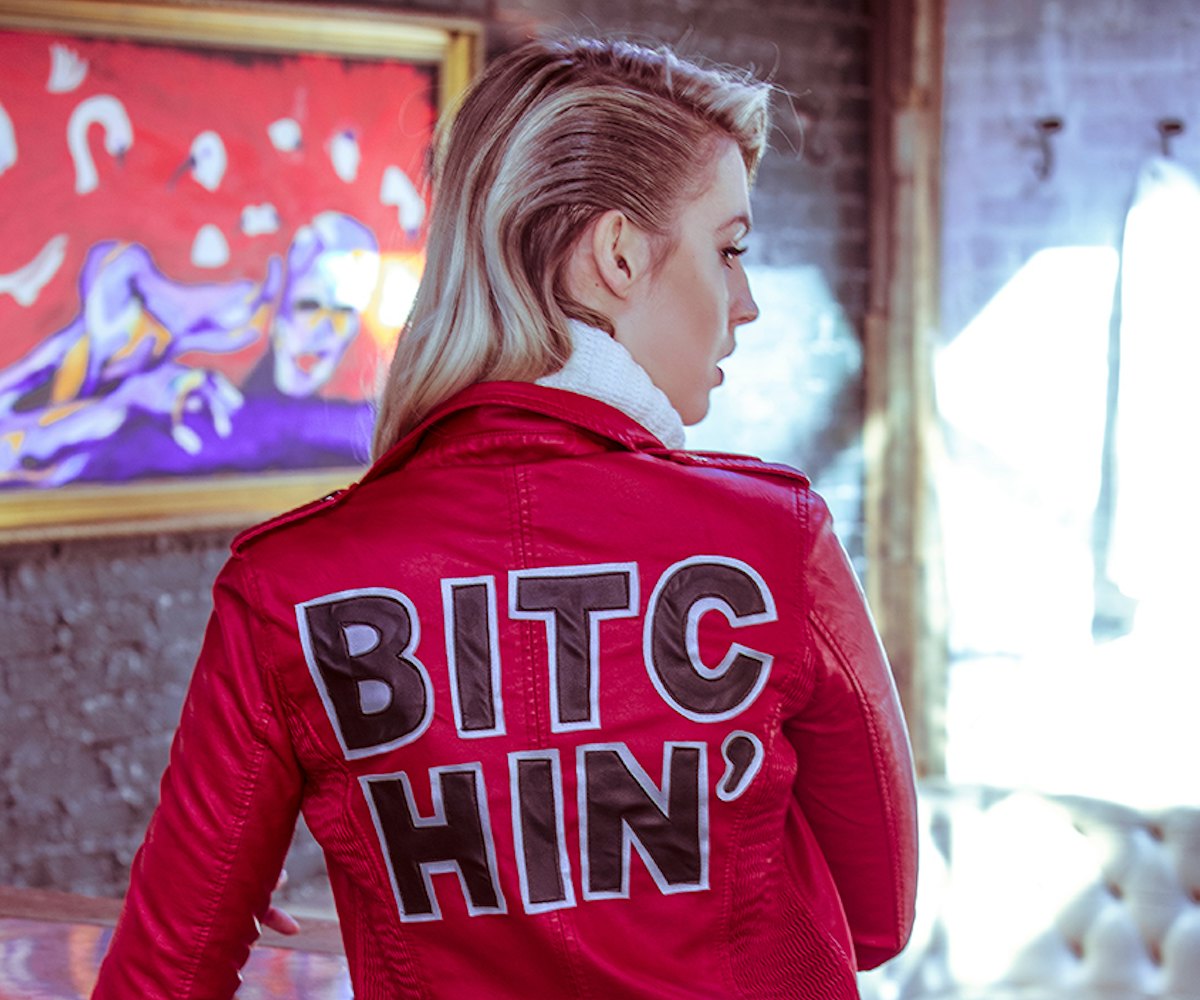 Beatriz Grander posing in a red High Heels Suicide, Bitchin' Moto jacket