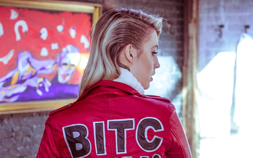 Beatriz Grander posing in a red High Heels Suicide, Bitchin' Moto jacket