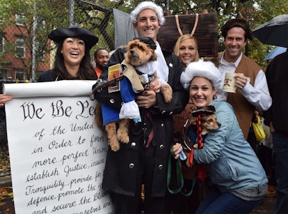 A dog and its owners dressed up as Abraham Lincoln and other attendees of the Declaration of Indepen...