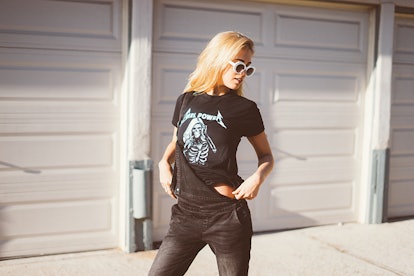 A blonde woman wearing a black t-shirt and white glasses with a skull from NYLONshop and Petals and ...