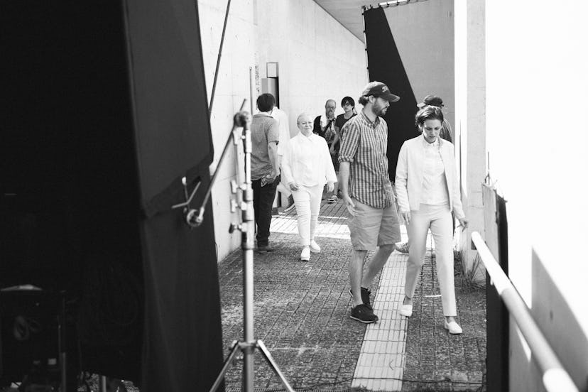 Nicholas Hoult and Kristen Stewart walking together on a set