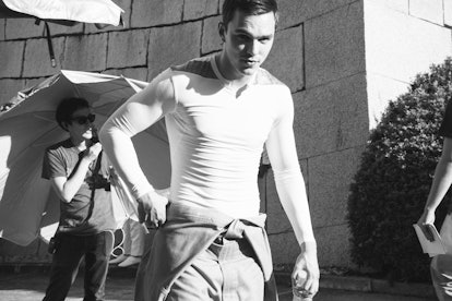 Nicholas Hoult walking while wearing a tank top 
