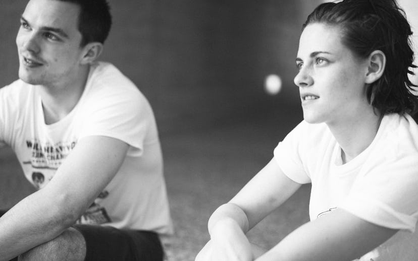 Nicholas Hoult and Kristen Stewart sitting on the ground