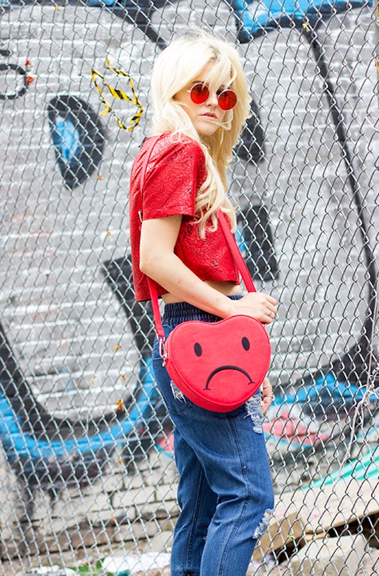 Rachel Lynch in a red Mother Mary Crop top, Publish, Megan Medium indigo pants and a Valfre Heartbre...