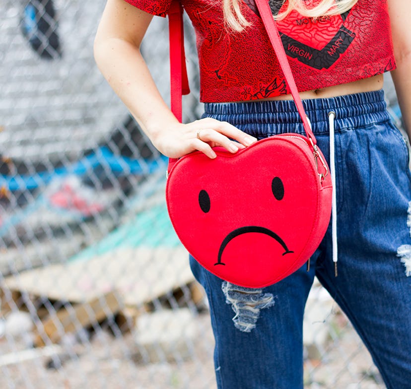A closeup of the red Mother Mary Crop top, Megan Medium indigo pants and the Valfre Heartbreaker pur...