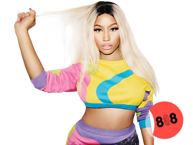 Nicki Minaj in a cropped yellow sweater with one pink sleeve and one purple sleeve, and turquoise de...