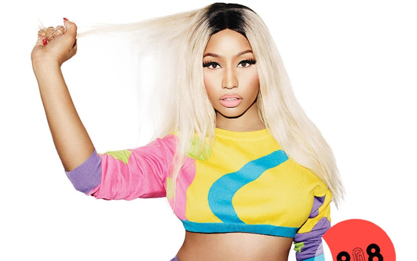 Nicki Minaj in a cropped yellow sweater with one pink sleeve and one purple sleeve, and turquoise de...