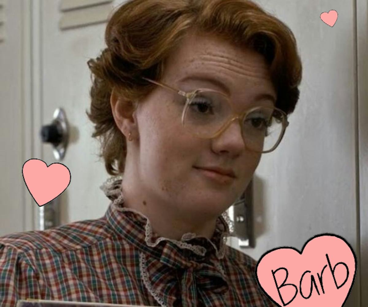 Shannon Purser as Barb standing next to the school's locker while talking to another person in the S...