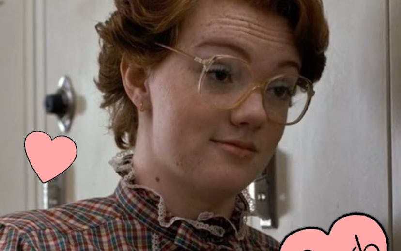 Shannon Purser as Barb standing next to the school's locker while talking to another person in the S...