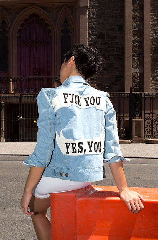 Lynn Kim wearing a white top, white skirt, and a denim jacket with "Fuck you, yes you" text