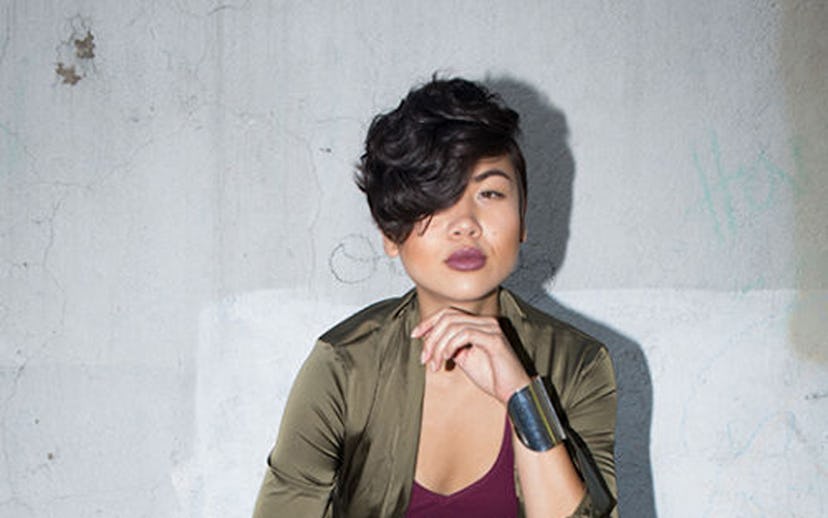 Lynn Kim in light ripped jeans, a burgundy top and an olive jacket