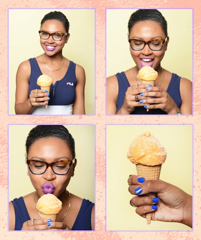 A woman with short black hair and purple lipstick eating ice cream 