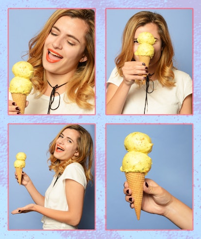 A woman in a white T-shirt eating a yellow ice cream cone