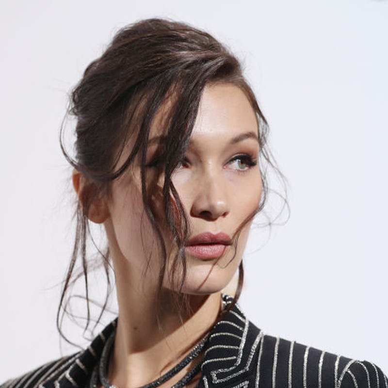 Brunette Bella Hadid wearing a striped blazer