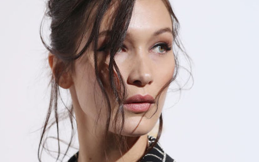 Brunette Bella Hadid wearing a striped blazer