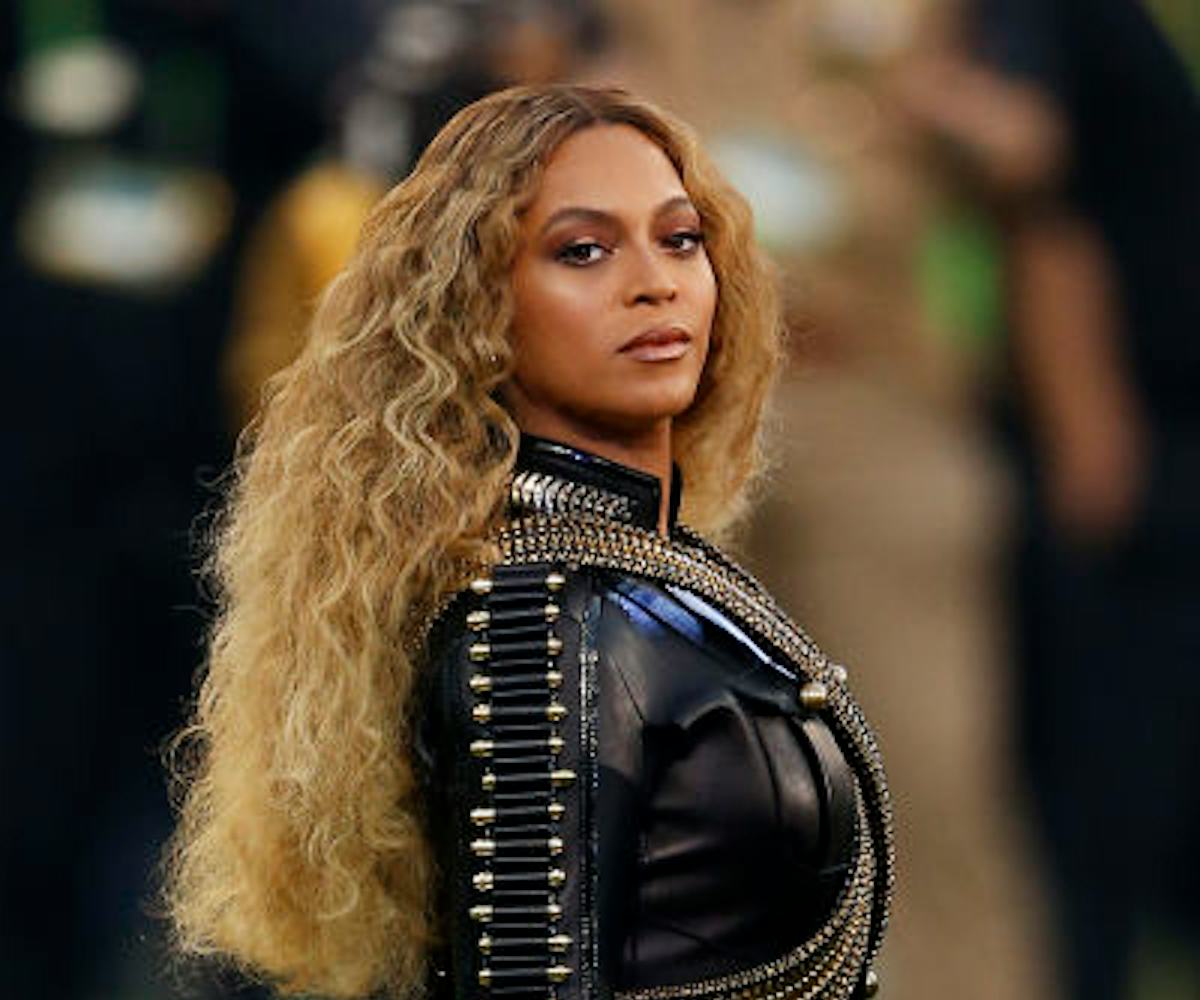 Beyoncé in a black leather jacket and shorts with long wavy hair during her 2016 Superbowl performan...