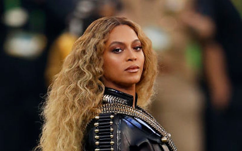Beyoncé in a black leather jacket and shorts with long wavy hair during her 2016 Superbowl performan...