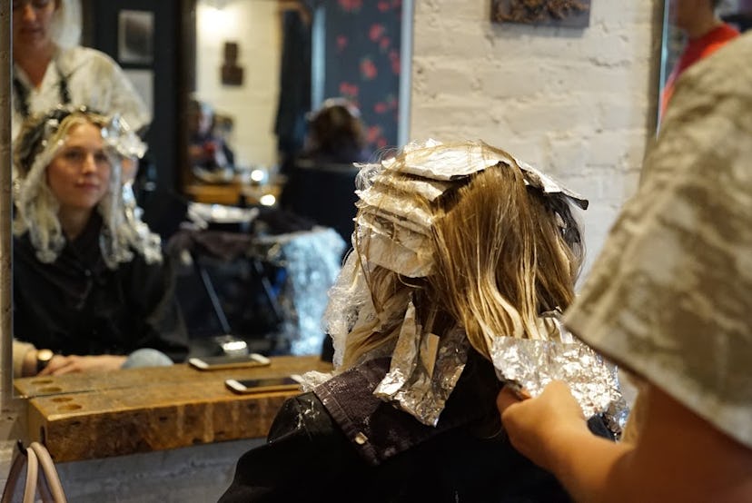 A woman at the salon getting highlights 