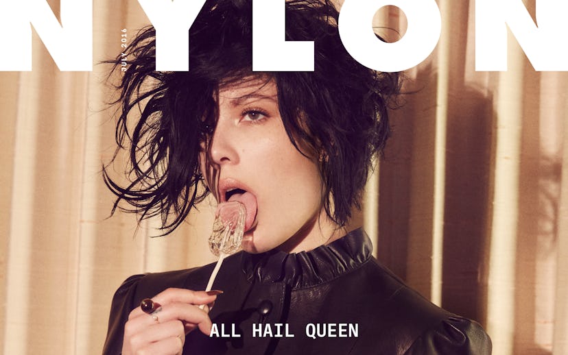 Halsey wearing a messy hairstyle while licking a lollipop