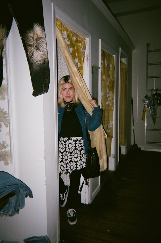 A woman coming out of a dressing room in a store