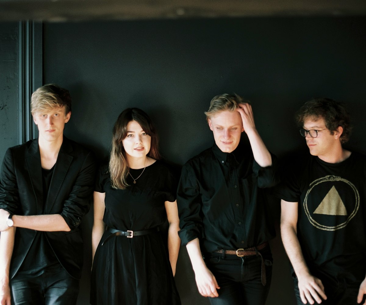 Yumi Zouma members posing for a photo while wearing all-black outfits