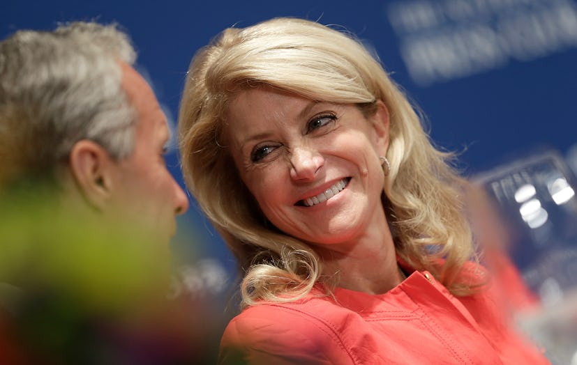 Wendy Davis smiling while wearing a coral jacket