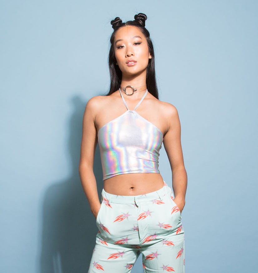 Holographic Halter Crop Top on a model in light blue pants and pigtails in her hair