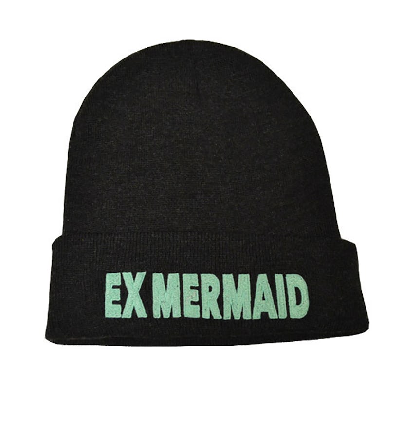 Black beanie with EX MERMAID text on it in green