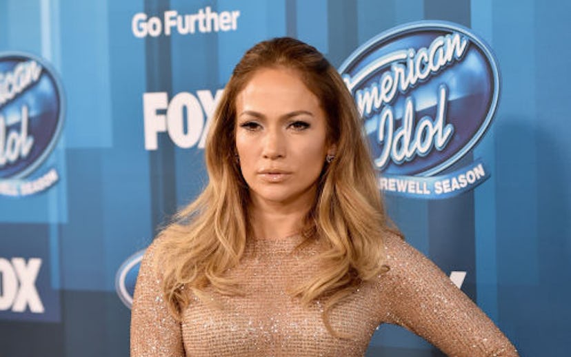 Jennifer Lopez posing in a gold sparkly dress at the American Idol event
